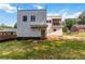 Rear exterior view of home with siding, second story porch, wooden back door, and ample yard space at 1554 Columbia Cir, Decatur, GA 30032