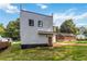 Rear exterior view of home featuring siding, wooden back door, and grassy yard space at 1554 Columbia Cir, Decatur, GA 30032