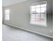 Bright bedroom with gray carpet and two windows at 1909 Sawgrass Dr, Hampton, GA 30228