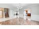 Spacious open-concept living area with a staircase, fireplace, and seamless flow into the kitchen at 1909 Sawgrass Dr, Hampton, GA 30228