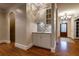 Convenient bar area with custom cabinetry, tile backsplash, and easy access to the entryway at 1984 Mendenhall Cir, Atlanta, GA 30341