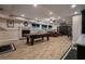 Recreational room in a finished basement with a pool table, fireplace, and wood-look laminate floors at 1984 Mendenhall Cir, Atlanta, GA 30341
