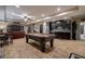 Spacious finished basement featuring a pool table, wet bar, seating area, and laminate wood flooring at 1984 Mendenhall Cir, Atlanta, GA 30341