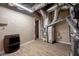 Unfinished basement area with exposed ductwork, wood-look floors, and essential utilities at 1984 Mendenhall Cir, Atlanta, GA 30341