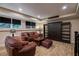 A finished basement with dark wood accent doors, laminate flooring, and two sofas at 1984 Mendenhall Cir, Atlanta, GA 30341