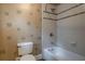 The bathroom features a white tub and shower, and a toilet with a decorative accent wall at 1984 Mendenhall Cir, Atlanta, GA 30341