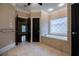 Serene bathroom boasts a soaking tub, decorative window, and neutral finishes at 1984 Mendenhall Cir, Atlanta, GA 30341