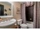 Charming bathroom featuring a pedestal sink, tiled shower-tub combination and decorative patterned shower curtain at 1984 Mendenhall Cir, Atlanta, GA 30341