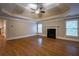 Large primary bedroom boasts gleaming hardwood floors, a cozy fireplace, and a stylish tray ceiling at 1984 Mendenhall Cir, Atlanta, GA 30341