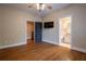 Open bedroom with hardwood floors, ceiling fan, and attached bath at 1984 Mendenhall Cir, Atlanta, GA 30341