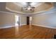 Open bedroom featuring hardwood floors, a tray ceiling, a fireplace, and three entryways at 1984 Mendenhall Cir, Atlanta, GA 30341