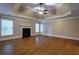Expansive bedroom features a tray ceiling, fireplace, and gleaming hardwood floors at 1984 Mendenhall Cir, Atlanta, GA 30341