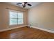 The bedroom has hardwood floors, a window, a ceiling fan and neutral wall paint at 1984 Mendenhall Cir, Atlanta, GA 30341