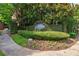 Stone community sign surrounded by manicured hedges and beautiful landscaping at 1984 Mendenhall Cir, Atlanta, GA 30341