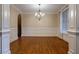 Dining room featuring hardwood floors, detailed wall paneling, and an elegant chandelier at 1984 Mendenhall Cir, Atlanta, GA 30341