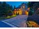Stone exterior home with manicured lawn, landscape lighting, and attached two-car garage at 1984 Mendenhall Cir, Atlanta, GA 30341