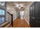 Hallway boasts beautiful hardwood floors, elegant staircase, and modern ceiling fan at 1984 Mendenhall Cir, Atlanta, GA 30341