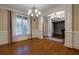 Living room showcasing hardwood floors, detailed trim, and an open view to the office with a piano at 1984 Mendenhall Cir, Atlanta, GA 30341