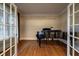 Office space showcasing french doors, hardwood floors, and a grand piano at 1984 Mendenhall Cir, Atlanta, GA 30341