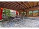 Charming outdoor patio with stone flooring, curtains, and wrought iron furniture at 1984 Mendenhall Cir, Atlanta, GA 30341