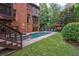 Lush backyard with pool, spa and patio furniture surrounded by verdant landscaping at 1984 Mendenhall Cir, Atlanta, GA 30341