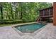 Backyard pool and spa with stone surround and lush, mature trees at 1984 Mendenhall Cir, Atlanta, GA 30341