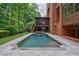 Beautiful backyard pool and spa with stone surround and mature landscaping at 1984 Mendenhall Cir, Atlanta, GA 30341