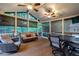 Relaxing sunroom with ceiling fans, comfortable seating, and views of the surrounding trees at 1984 Mendenhall Cir, Atlanta, GA 30341