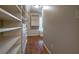 Bright walk-in closet boasts custom shelving and hardwood floors at 1984 Mendenhall Cir, Atlanta, GA 30341