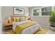 Inviting bedroom with natural light, featuring a bed with a wooden headboard and colorful accents at 340 Bell Se St, Marietta, GA 30060