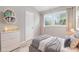 Cozy bedroom with neutral tones, featuring a comfortable bed, dresser, and natural light from windows at 340 Bell Se St, Marietta, GA 30060
