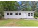 Charming single-story home with a white exterior, complemented by well-maintained landscaping and mature trees at 340 Bell Se St, Marietta, GA 30060