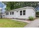 Inviting single-story home with a freshly painted white exterior, enhanced by manicured lawn and concrete walkway at 340 Bell Se St, Marietta, GA 30060