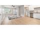 Open living space with wood floors, neutral walls, an area rug, and a modern kitchen with stainless steel appliances at 340 Bell Se St, Marietta, GA 30060