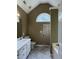 Bathroom featuring a large vanity sink and countertop, toilet, shower stall and a large arched window at 645 Robin Rd, Covington, GA 30016