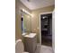 Bathroom features a modern vanity with a white sink, chrome fixtures and a decorative mirror at 645 Robin Rd, Covington, GA 30016