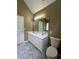 Bathroom featuring a double-sink vanity with a large mirror, toilet, and marble-look tile flooring at 645 Robin Rd, Covington, GA 30016