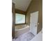 Bathroom featuring a bathtub and a window with blinds, providing natural light and a relaxing ambiance at 645 Robin Rd, Covington, GA 30016