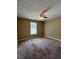 This bedroom features neutral paint, plush carpet, a ceiling fan, and a bright window at 645 Robin Rd, Covington, GA 30016