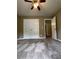 Bedroom with double-door closet featuring carpet flooring and access to other rooms of the home at 645 Robin Rd, Covington, GA 30016