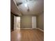 This is a spacious bedroom with wooden floors, a ceiling fan, and two entrances at 645 Robin Rd, Covington, GA 30016