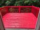 Inviting red deck perfect for outdoor relaxation and enjoyment with lush greenery in the background at 645 Robin Rd, Covington, GA 30016
