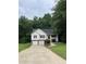 Charming two-story home with a two-car garage and well-manicured lawn, surrounded by lush trees at 645 Robin Rd, Covington, GA 30016