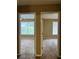Hallway view showing doorways to two carpeted rooms, with natural light streaming through the windows at 645 Robin Rd, Covington, GA 30016