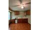Well-equipped kitchen with ample cabinet space, tile floors, and a ceiling fan for added comfort at 645 Robin Rd, Covington, GA 30016