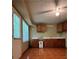 Charming kitchen boasts warm cabinets, tile flooring, and a ceiling fan for added comfort at 645 Robin Rd, Covington, GA 30016