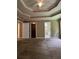 Spacious main bedroom featuring tray ceilings and carpet flooring, with walk-in closet and bathroom access at 645 Robin Rd, Covington, GA 30016