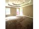 Spacious main bedroom with a tray ceiling, ceiling fan, and neutral carpeting at 645 Robin Rd, Covington, GA 30016