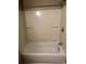 This shower has a bathtub, shower, and built in shelves at 645 Robin Rd, Covington, GA 30016
