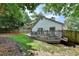 A well-maintained backyard with green lawn, partial fence, and a deck offers outdoor space for Gathering activities at 1133 Capital Club Ne Cir, Brookhaven, GA 30319